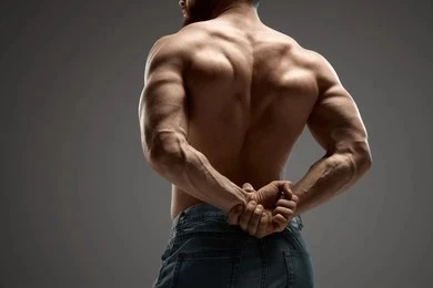 A man flexing his muscles, back pose