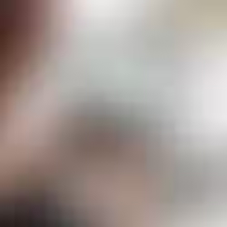 Person typing on a laptop displaying analytics charts in a bright office.