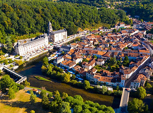 Scenic drone view of Brantome en Perigord on Dronne river with former Benedictine abbey on