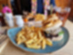 Burger with fries and ale served in an English country pub