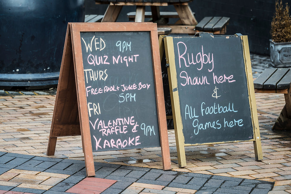 Cartello con orari del pub quiz esposto fuori da un pub inglese
