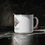Thumbnail: Enamel Camp Mug – “Ancient Wisdom, Modern Healing”