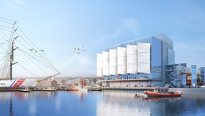 A four story building with white, sail-like, appendages sits on the water front. A rigged sailing ship and a small orange boat are also visible.