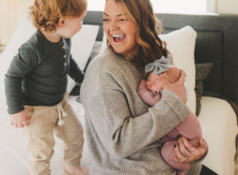 Mom with two kids on bed