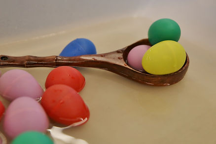 Coloured eggs and a wooden spoon
