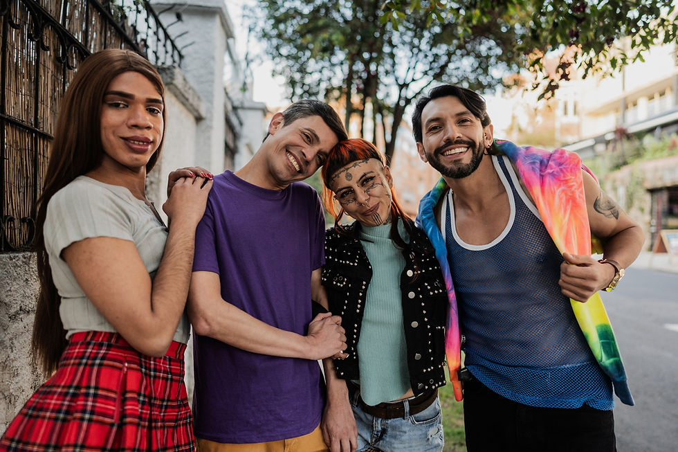 Four people smiling together in an outdoor community setting.