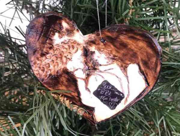 An inspired piece of the wood burned portion as a miniature size replica, a 3” Christmas ornament