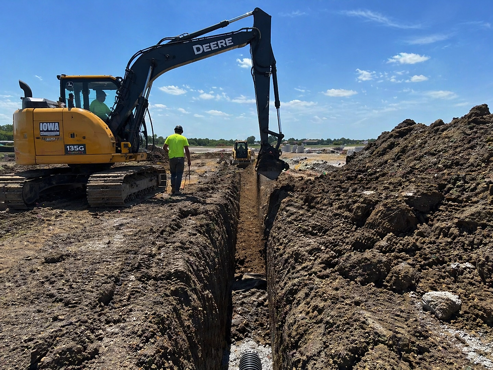 John Deere excavator digging a trench