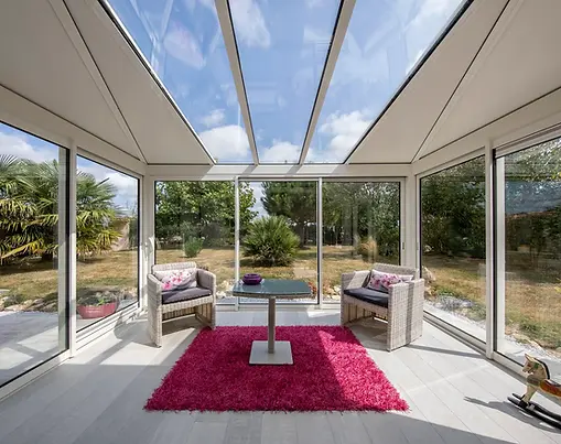 Luxury four-season sunroom featuring custom glass walls safely supported by an AV Composites insulated roof system.