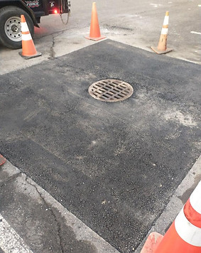 asphalt patch around commercial drain