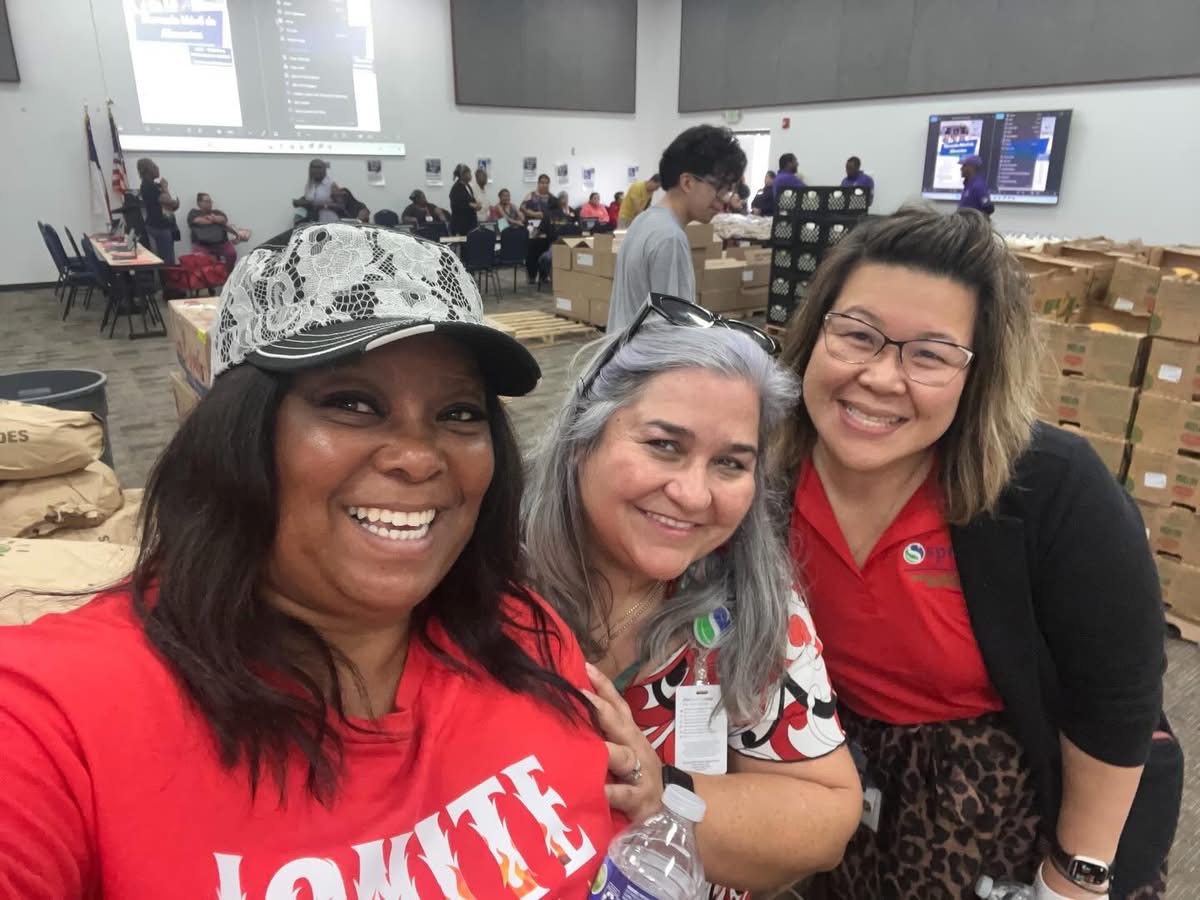 Smiling volunteers working together at the outreach event
