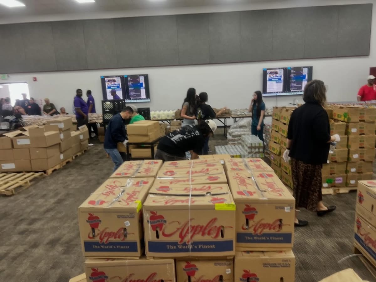 Volunteers organizing boxes and supplies for community outreach