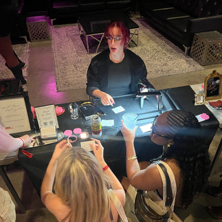 Live event artist Arielle Basha engraving personalized compact mirrors for VIP guests at a concert activation in Atlanta
