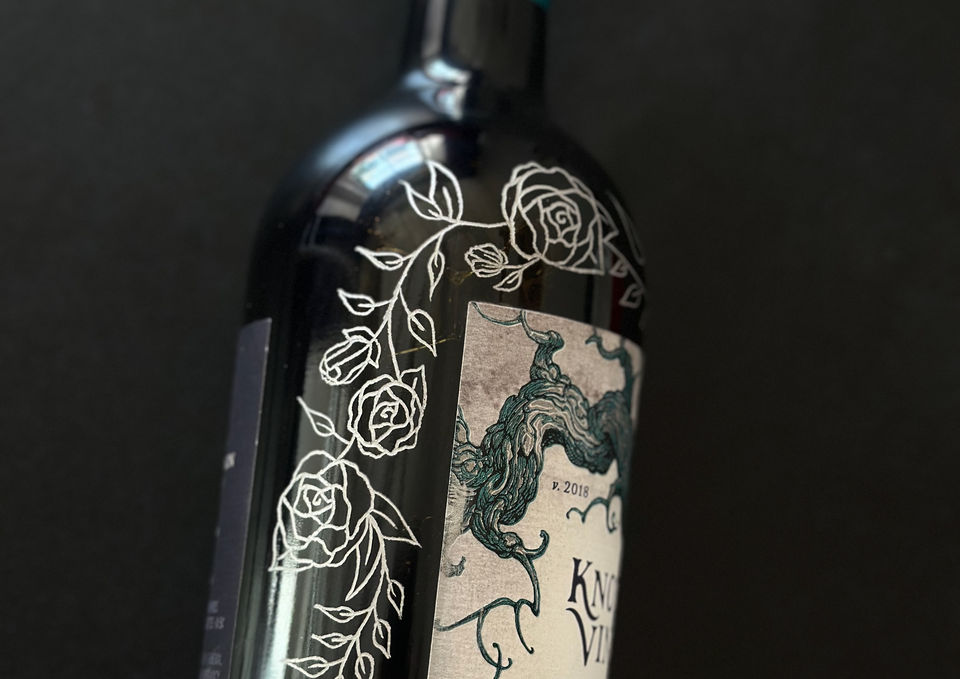 Engraved wine bottles with custom calligraphy and floral illustration for a milestone anniversary gift