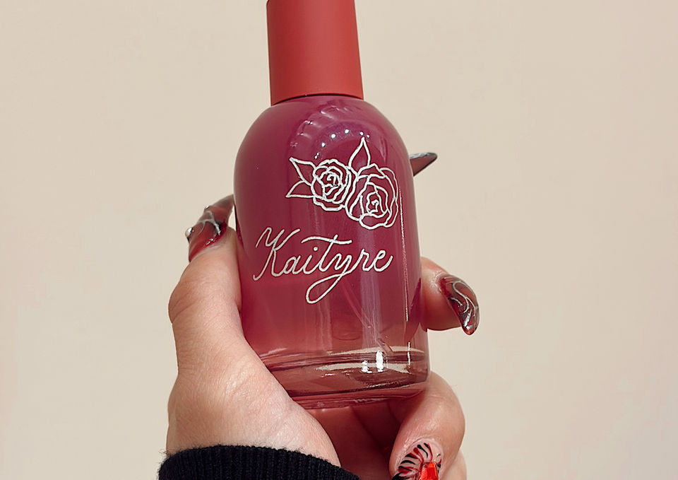 Branded live calligraphy for Glossier's in-store event, writing guest names on fragrance bottles