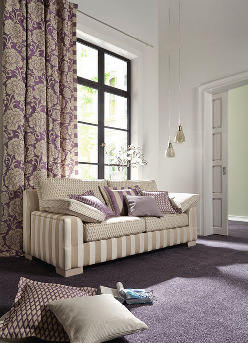 Wohnzimmer-Sofa mit Vorhängen und Kissen