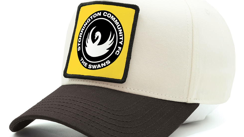 Eye-level view of a colorful patch cap displayed on a wooden table