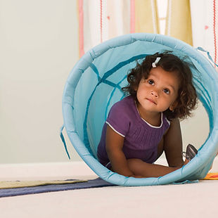 Girl peeking through tunnel