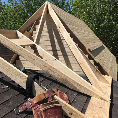 Timber‑frame patio cover added to a Youngsville home.