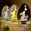 Miniatura: Elegante lampada pasquale in legno a forma di uovo con intaglio di coniglietto e farfalle, illuminata con luce soffusa.