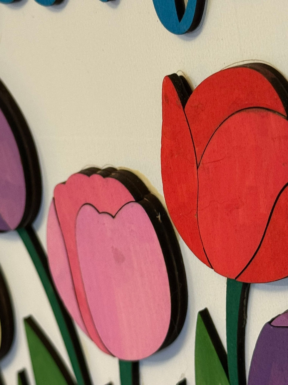 Thumbnail: Colorful wooden tulip wall art in red, pink, and purple