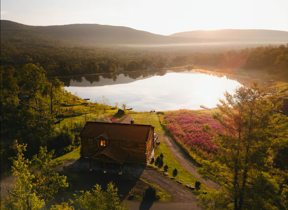Aerial view of Catskills chalet and lake at sunset