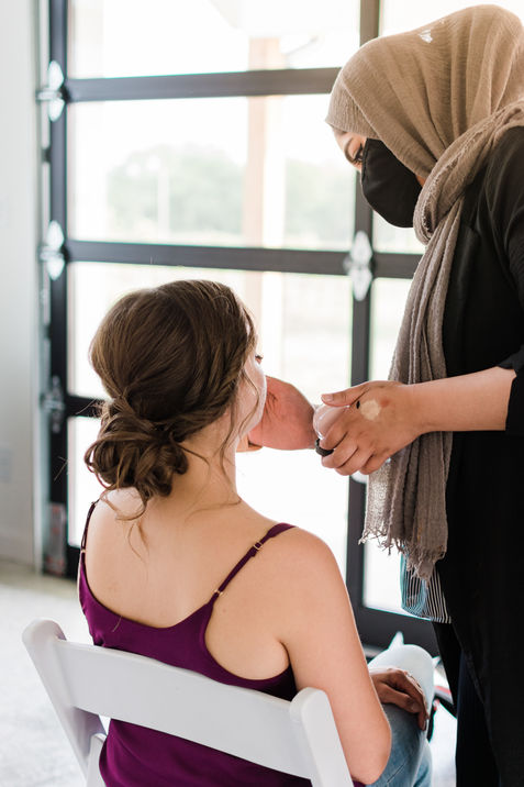 Mallory Cook Wedding Styled Shoot Bride Model having makeup applied with an updo in her hair.