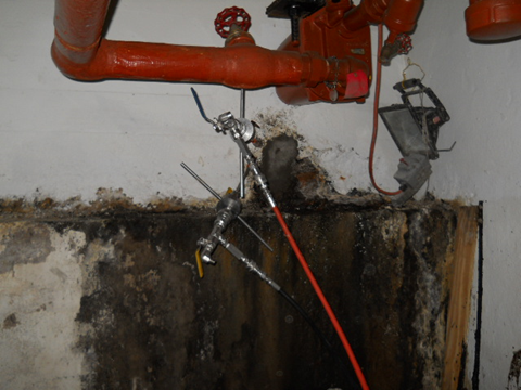 DURING - HVAC Room Oily Water Infiltration, Injection Manual Tools Inserted within Drilled Holes
