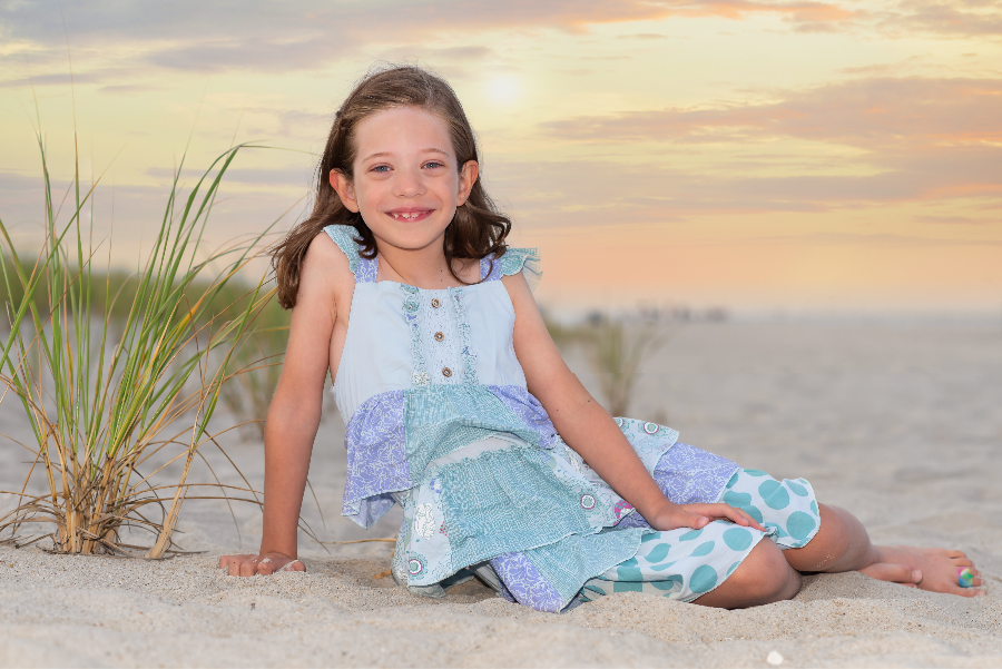 photo of a girl sitting on a beach