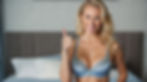 a beautiful blonde haired woman in blue lingerie giving a thumbs up