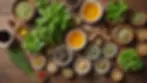 High angle view of various herbs and supplements on a wooden table