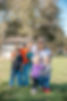 A mother and her four kids posing together.