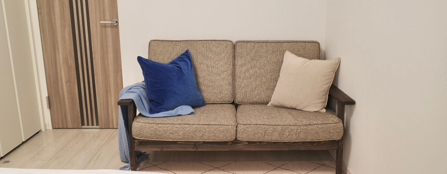 Modern living area with minimalist sofa and natural lighting in a furnished in Tokyo shinjuku central park Apartment Lohus serviced apartment for expats.