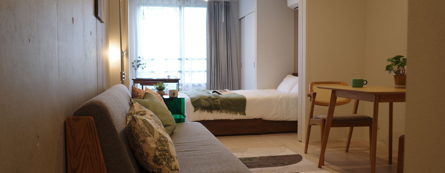 Modern living area with minimalist sofa and natural lighting in a furnished in Tokyo Otsuka Apartment Lohus serviced apartment for expats.