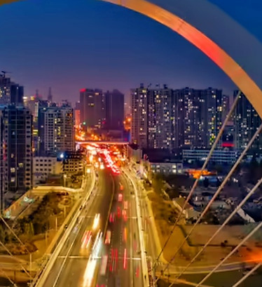Image of a futuristic city bridge at night