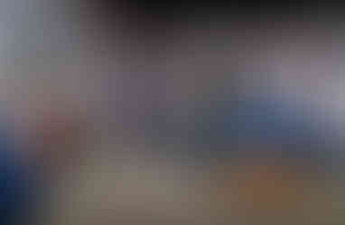 Vintage living room with blue sofas, red-brick fireplace, and paintings. A yellow pillow adds color. Calm, nostalgic atmosphere.