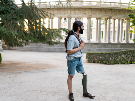 Traveling as an Amputee: Man with a prosthetic leg standing confidently on a scenic hiking trail during a walk