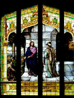 Stained glass window depicting Jesus talking to a man