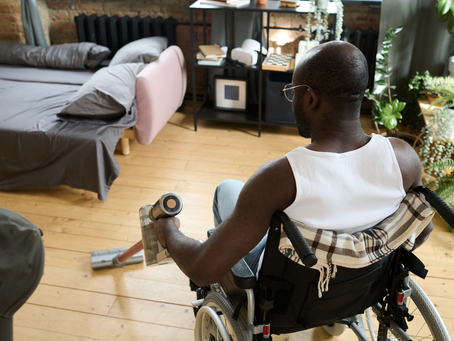 "Amputee using a prosthetic leg while cleaning their new home after relocating, showcasing independence and resilience.