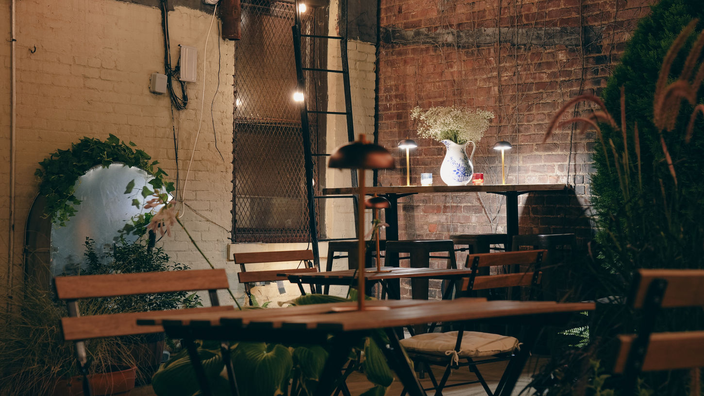 Cafe 9’s cozy outdoor seating area in Astoria, NY, is perfect for enjoying coffee and snacks and hosting intimate events.