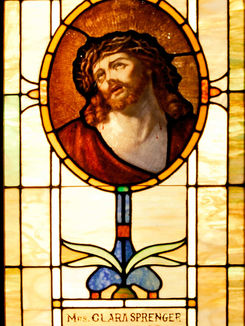 Stained glass window depicting Jesus with a crown of thorns.