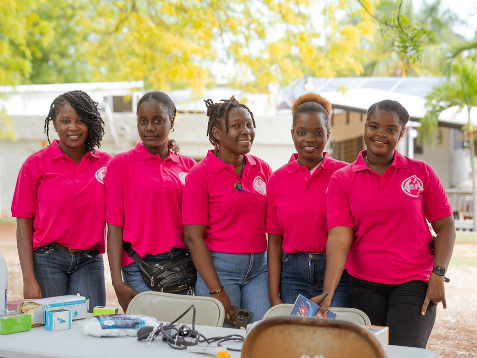 Five women in midwifery programs in Haiti smiling.
