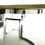 Thumbnail: Detail of the side of a Milo Baughman style table in black and chrome
