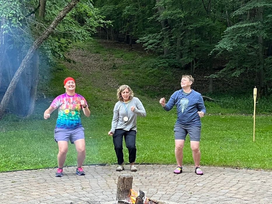 Avanti staff leading song during campfire