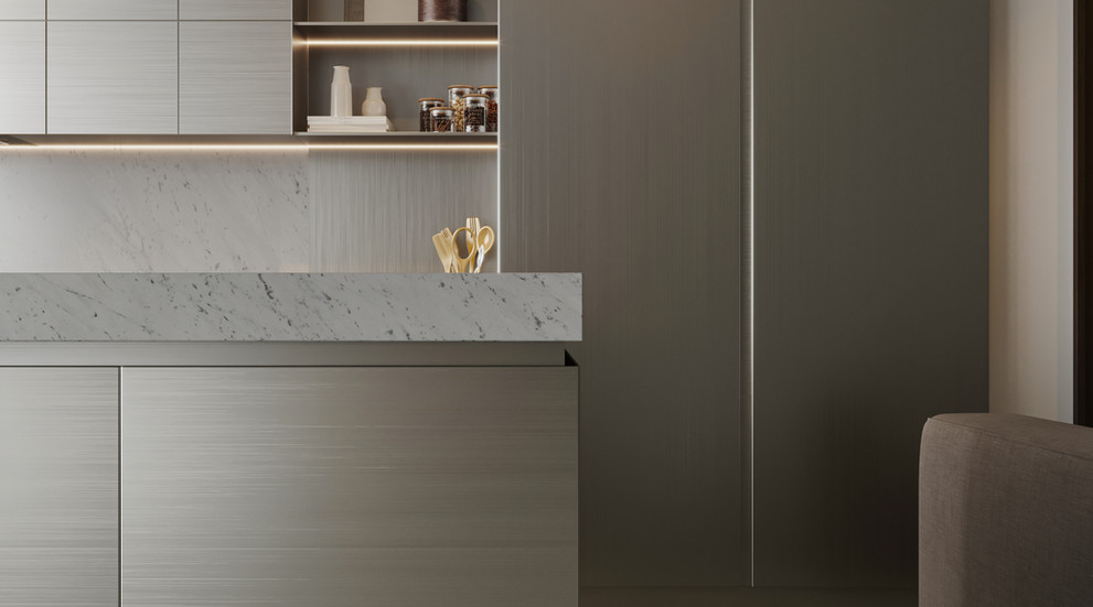 Close-up of a modern kitchen corner featuring sleek gray cabinetry, a white marble countertop with subtle veining, under-cabinet lighting, open shelves with jars and decor, and a tall matte-finish refrigerator on the right.