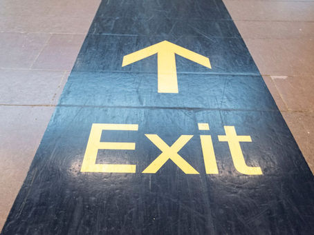 Exit Package.  The word exit and an arrow written in tiles on the floor.