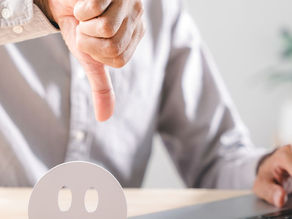 Personal Grievance. Auckland, Wellington, Christchurch. Man in front of computer with thumb down.