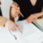 Personal Grievance. Advocate. Two people looking over a document with one offering guidance.