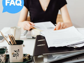 Complaint. Auckland, Wellington, Christchurch. Woman seated at desk with files and paperwork.