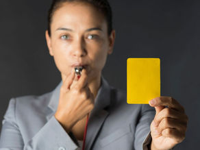 Stand-down. Suspension. Auckland, Wellington, Christchurch. Woman with a whistle holding a yellow card.